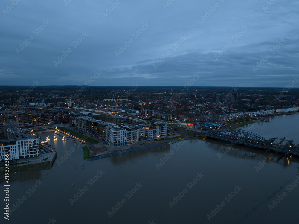 Fototapeta premium Aerial overview at dusk of the city of Zutphen, along the river Ijssel in Gelderland, The Netherlands. Birds eye aerial drone view in the Dutch province of Gelderland.
