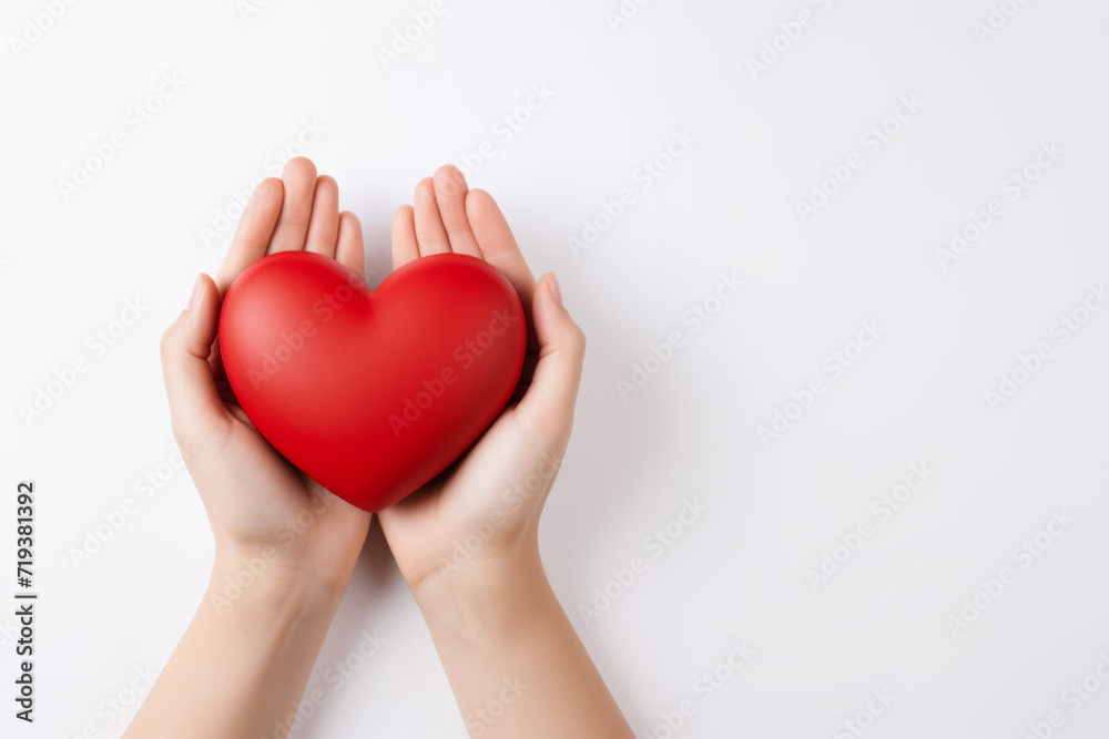 female hands holding an object in the shape of a red heart on a white background, concept for Valentine's Day, March 8, love. heart is bright red matte. free space for insertion female hands holding an object in the shape of a red heart on a white background, concept for Valentine's Day, March 8, love. heart is bright red matte. free space for insertion