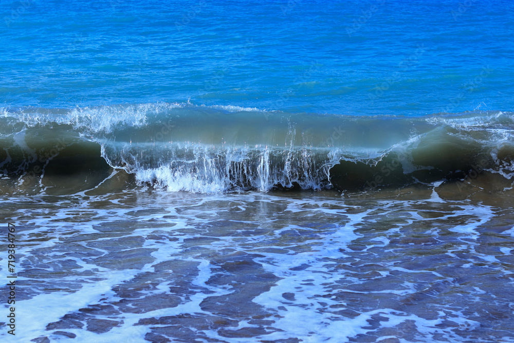 Obraz premium Sea waves. Seascape. Turbulent the sea. Vacation and summer concept. Powerful Ocean blue waves with white foam. Sea wave. Tourism. Travel. Marine nature. Large turquoise sea wave. Beautiful foam waves