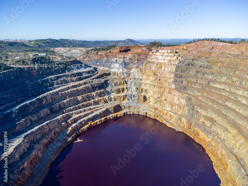 Aerial drone view of Corta Atalaya with mining levels at open mine pit. Deep excavation of pyrite and extraction of minerals of copper and gold in Minas de Riotinto, Huelva, Andalusia, Spain photo