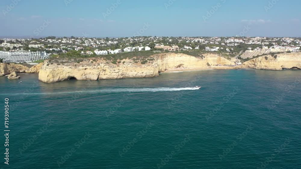 Aerial perspective of Algarve coastline. View of Armacao de Pera. Luxury hotels and urbanisation. Gloden beaches, turquoise water. High cliffs. Famous travel destination. Drone tracking right Aerial perspective of Algarve coastline. View of Armacao de Pera. Luxury hotels and urbanisation. Gloden beaches, turquoise water. High cliffs. Famous travel destination. Drone tracking right