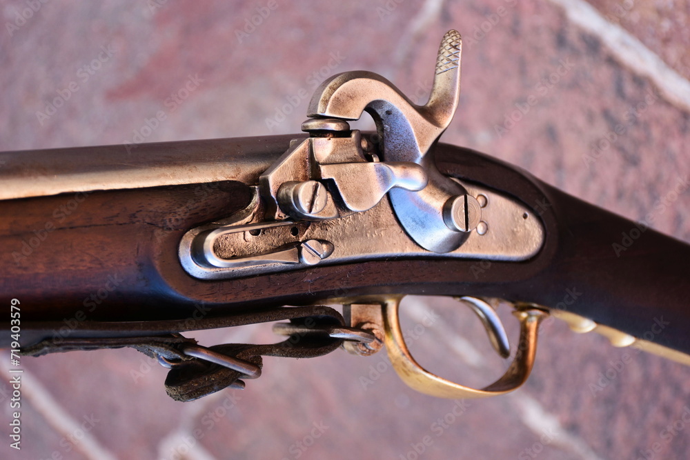 old vintage muzzleloading flintlock rifle closeup. shiny metal flint