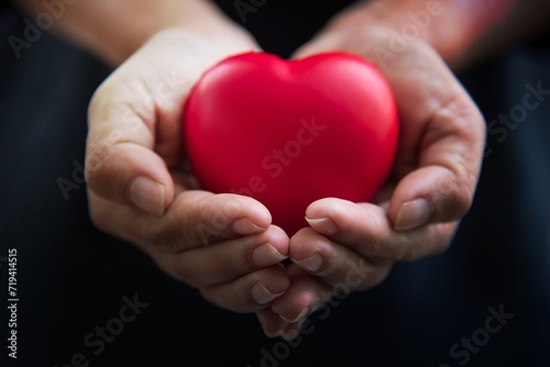 Close up hands giving red heart as heart donor. Valentine day of love concept. Medical ventilator and heart donator charity. Sign of compassion and healthy. Helping hand in freedom life donation