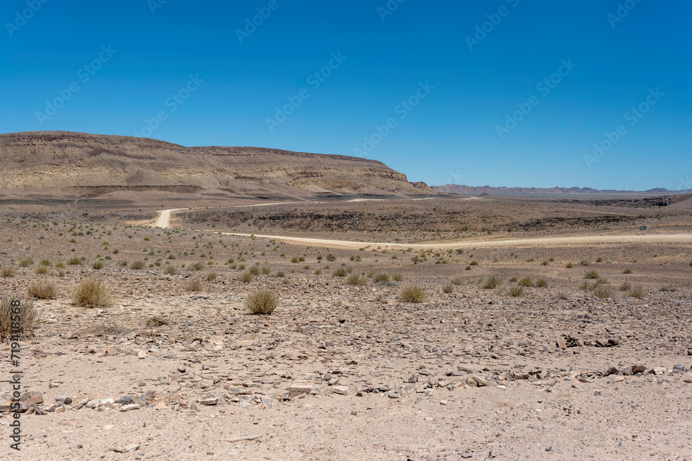 hills with layers of conglomerate and basalt and D324 gravel road in desert, near Hobas, Namibia hills with layers of conglomerate and basalt and D324 gravel road in desert, near Hobas, Namibia