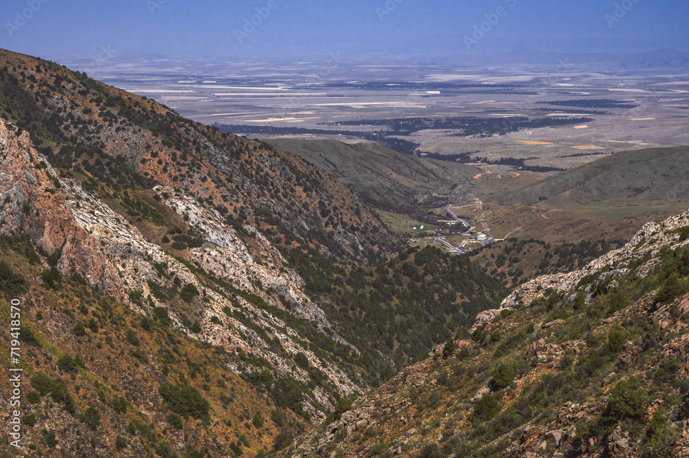View from the top of the mountains to a rural village in a valley in Kazakhstan in summer