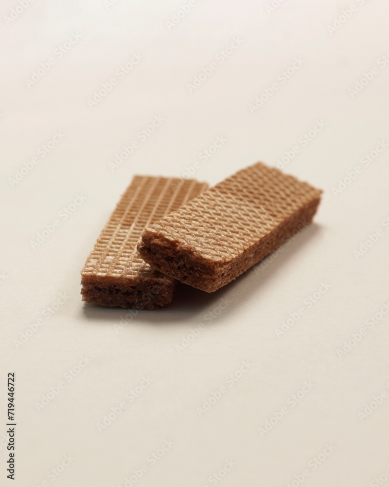 Wafers with chocolate flavored cream on a white and wooden background. Wafer With Chocolate Drizzle. A set of delicious crispy sweet wafers of different shapes. long, square, tasty and crunchy cake. Wafers with chocolate flavored cream on a white and wooden background. Wafer With Chocolate Drizzle. A set of delicious crispy sweet wafers of different shapes. long, square, tasty and crunchy cake.