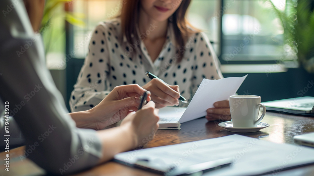 Show a candidate reviewing their notes from the interview before composing a follow-up message, highlighting their thoroughness and attention to detail. Show a candidate reviewing their notes from the interview before composing a follow-up message, highlighting their thoroughness and attention to detail.