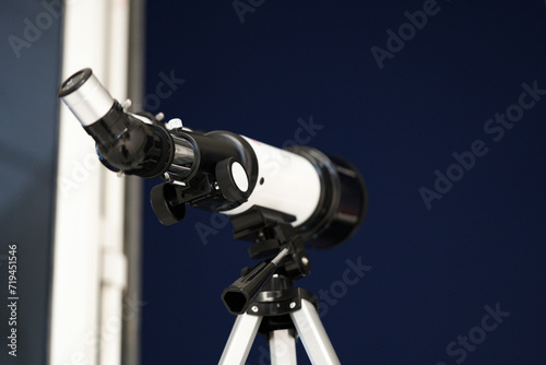 looking through a telescope. A white telescope to see the sky. Blue sky with stars star gazing, clear blue sky. 