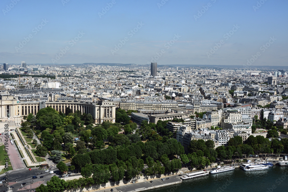 Drone view of the Trocadero Gardens in Paris, France and the Seine River. The modern part of the city with skyscrapers can be seen in the distance