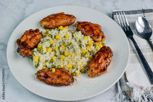 chicken wings with rice corn and peas