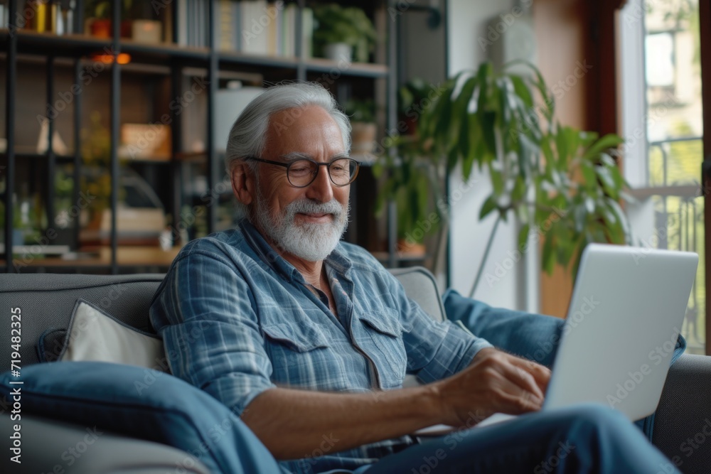 A man sitting on a couch using a laptop computer. Suitable for technology and work-related concepts A man sitting on a couch using a laptop computer. Suitable for technology and work-related concepts