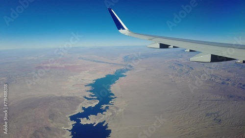 Plane window view flying over lake mead nevada arizona border desert usa deserted remote location photo