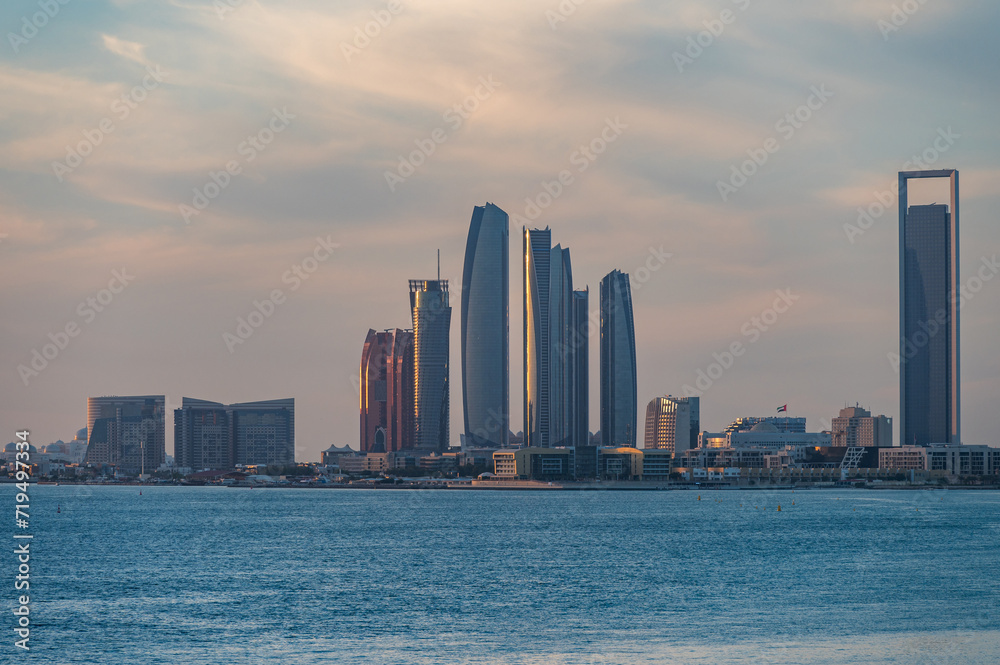 Perspective of skyscraper towers and bay cityscape skyline of Abu Dhabi, sunrise in UAE.