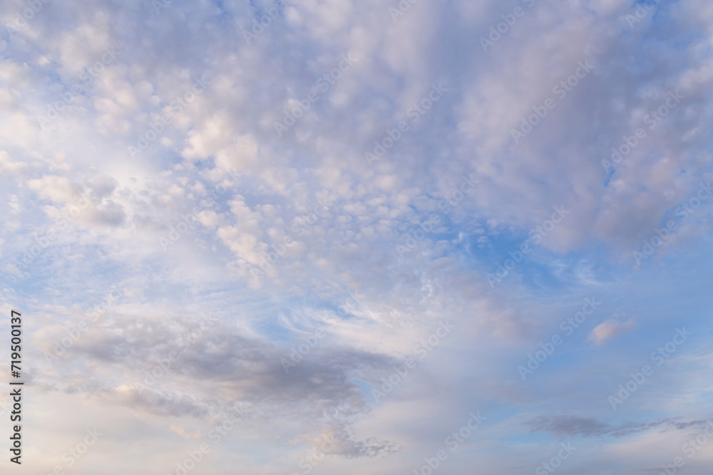 Beautiful epic soft gentle blue sky with white and grey cirrus and fluffy clouds background texture, heaven