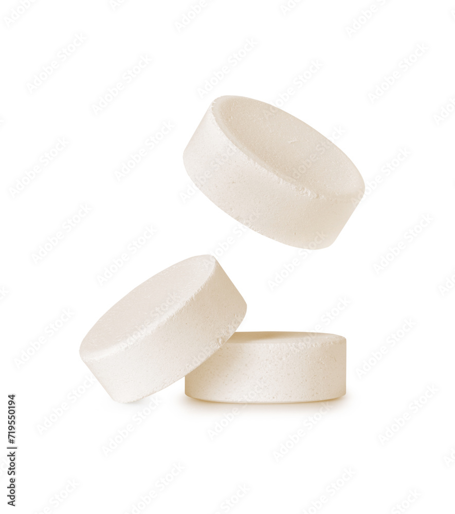 Three soluble tablets close-up. Effervescent multivitamin pills isolated on a white background