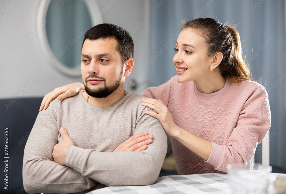 Obraz premium Stressed young adult man feeling irritated after argue with woman asking forgiveness and ignoring her