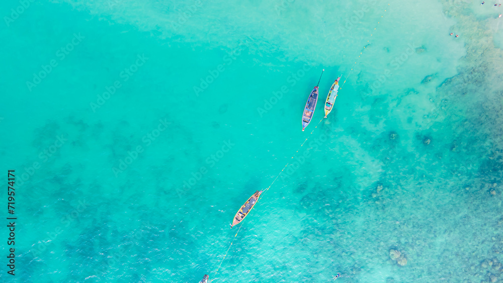 Obraz premium Paradise beach Phuket Patong. aerial top view amazing freedom beach small white sand beach with perfect nature. white wave hit the rock around island. green forest peaceful. green sea, landscape.