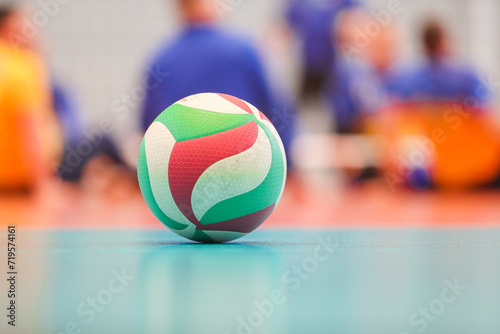 A volleyball ball is lying on the floor of the sports hall
