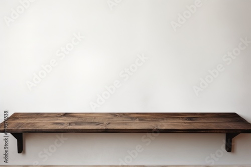 Empty wooden charcoal table over white wall background