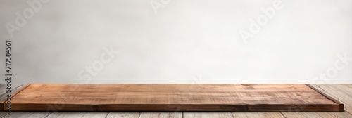Empty wooden slate table over white wall background