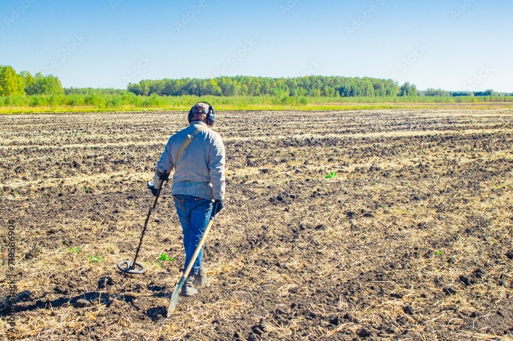 Metal search. A man holds a metal detector in his hand. Search for treasures. Search for antique coins. Metal search. A man holds a metal detector in his hand. Search for treasures. Search for antique coins.