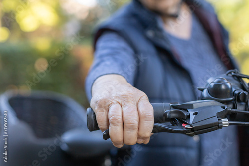 elderly woman's hand on bicycle handle