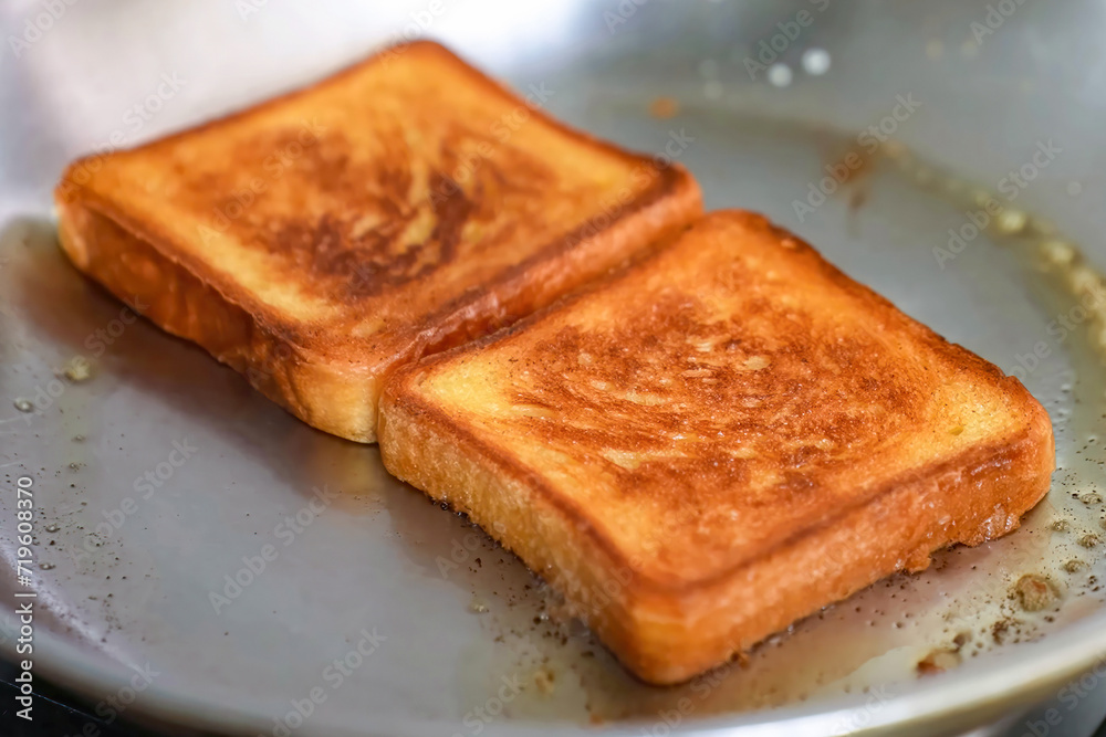 Cooking burger beef, toast on a hot frying pan close up. Preparing hamburger freshly baked, homemade. Grocery product advertising, menu. Cooking burger beef, toast on a hot frying pan close up. Preparing hamburger freshly baked, homemade. Grocery product advertising, menu.