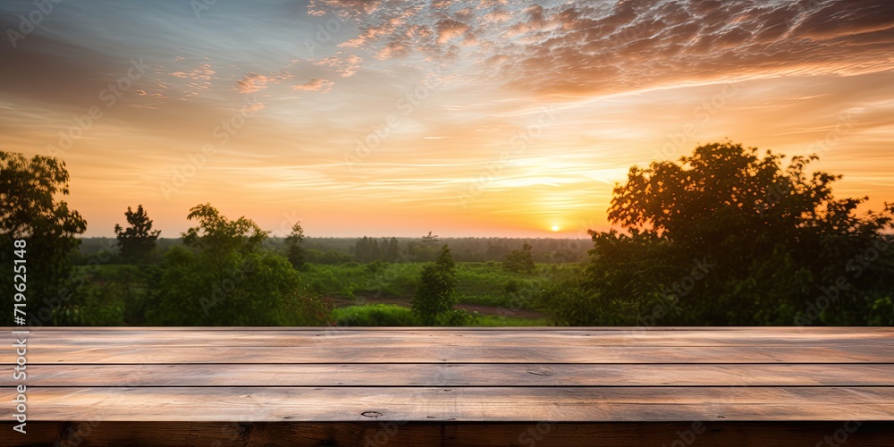 Sunrise over a bare wooden table with nature in the background.
