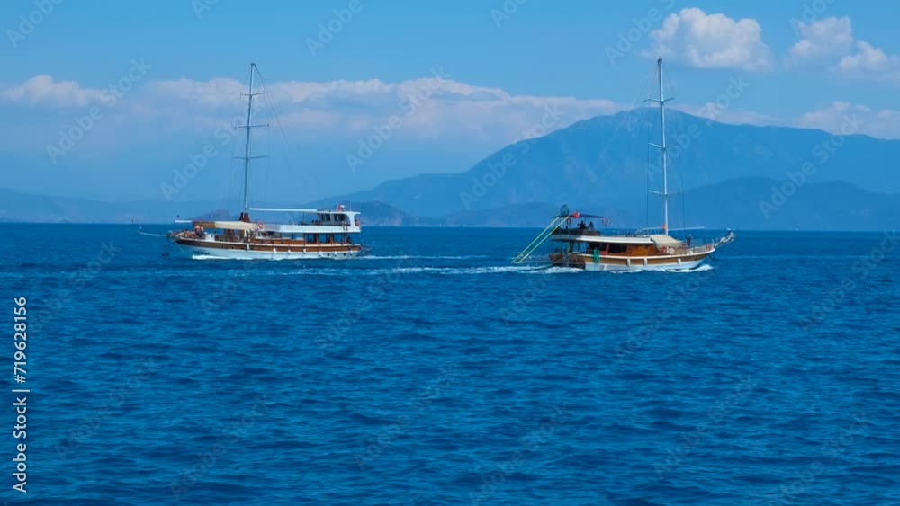 Sailing luxury yacht against cloudy sky. A view of traveling ships sailing in the open deep sea during weekend. A concept of floating leisure in summer. Sailing luxury yacht against cloudy sky. A view of traveling ships sailing in the open deep sea during weekend. A concept of floating leisure in summer.