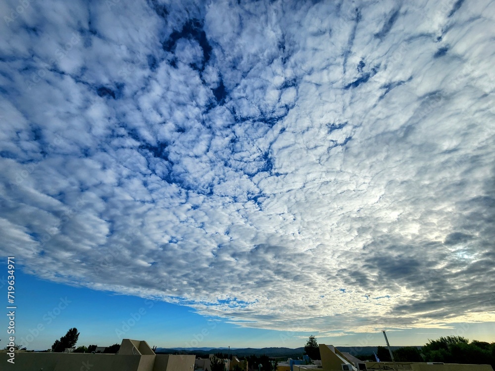 Cloudscape, Colored Clouds at Sunset near the Ocean on a Blue Sky