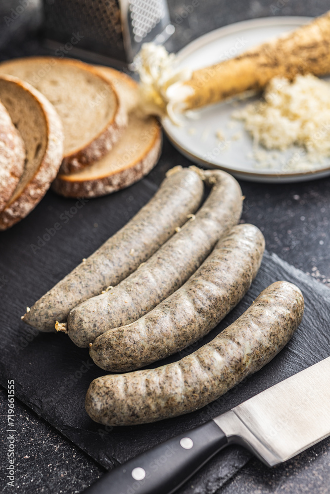 White pudding sausage. Pork product on cutting board on black table. White pudding sausage. Pork product on cutting board on black table.
