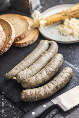 White pudding sausage. Pork product on cutting board on black table.