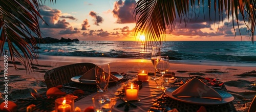 Romantic dinner on the beach with sunset candles with palm leaves and sunset sky and sea Amazing view honeymoon or anniversary dinner landscape Exotic island evening horizon romance for a coupl