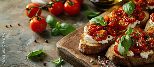 Tomato Ricotta Bruschetta with sun dried tomatoes paste olive oil brown bread and basil. Copy space image. Place for adding text photo