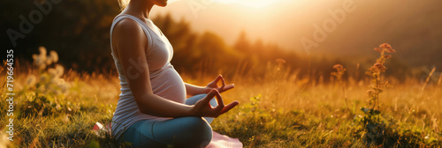 Pregnant Woman Meditating in a Field at Sunset