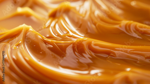 Macro photography of Flowing caramel. This versatile confection adds delicious, creamy flavor to desserts, pastries, and candies. Concept for National Caramel Day, April 5.