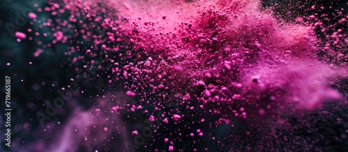 Pink dust debris isolated on black background motion powder spray burst in dark texture. Copy space image. Place for adding text