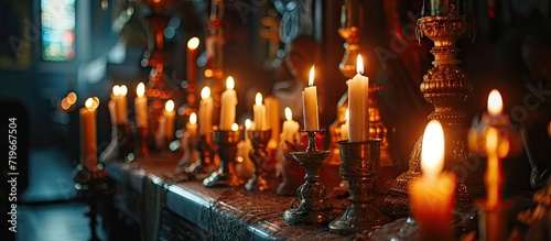 two burning candles for baptism in the orthodox church Christian faith and traditions Two burning candles in an orthodox church close up vertical orientation photo. Copy space image