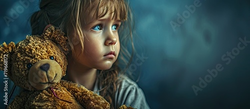 Upset sad child Little girl with a big teddy bear Problems with children. Copy space image. Place for adding text photo