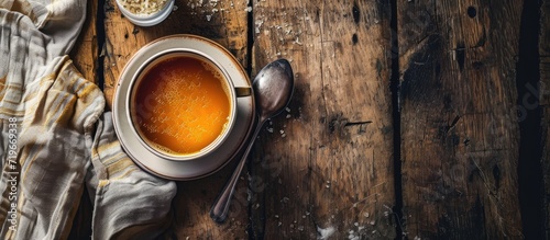 Saucepan with bouillon with a ladle on the table Bone broth. Copy space image. Place for adding text