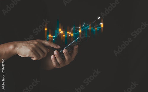 Hand of Businessman or trader is showing a growing virtual hologram stock on smartphone, invest in trading, planning and strategy, Stock market technology, Business growth, progress or success concept