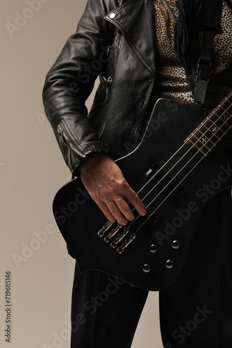 Cropped image of rock musician with electric guitar poses at the studio.Mock-up.