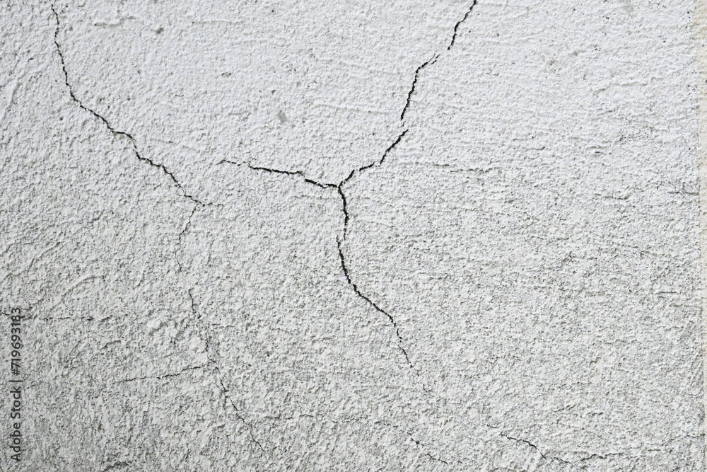Cracks on the gray wall. Cement background. The concept of unfinished repairs. Cracks on the gray wall. Cement background. The concept of unfinished repairs.