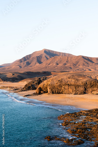 Playa Del Pozo and Hacha Grande mountain in the background, Lanzarote Island. Canary, Macaronesia, Spain. Vertical framing.