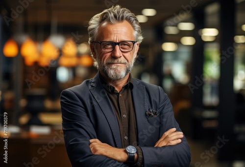 A distinguished gentleman gazes intently, his sharp features framed by a neatly trimmed beard and stylish glasses, his tailored suit accentuating his refined taste, while a sleek watch on his wrist h