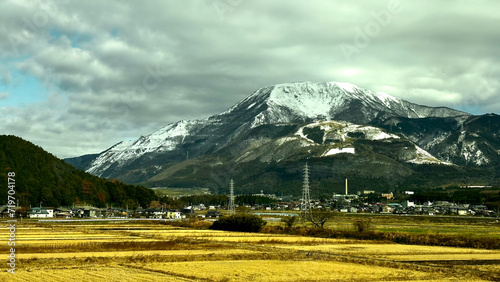 Scenic view of snowy mountain with a town in front of it