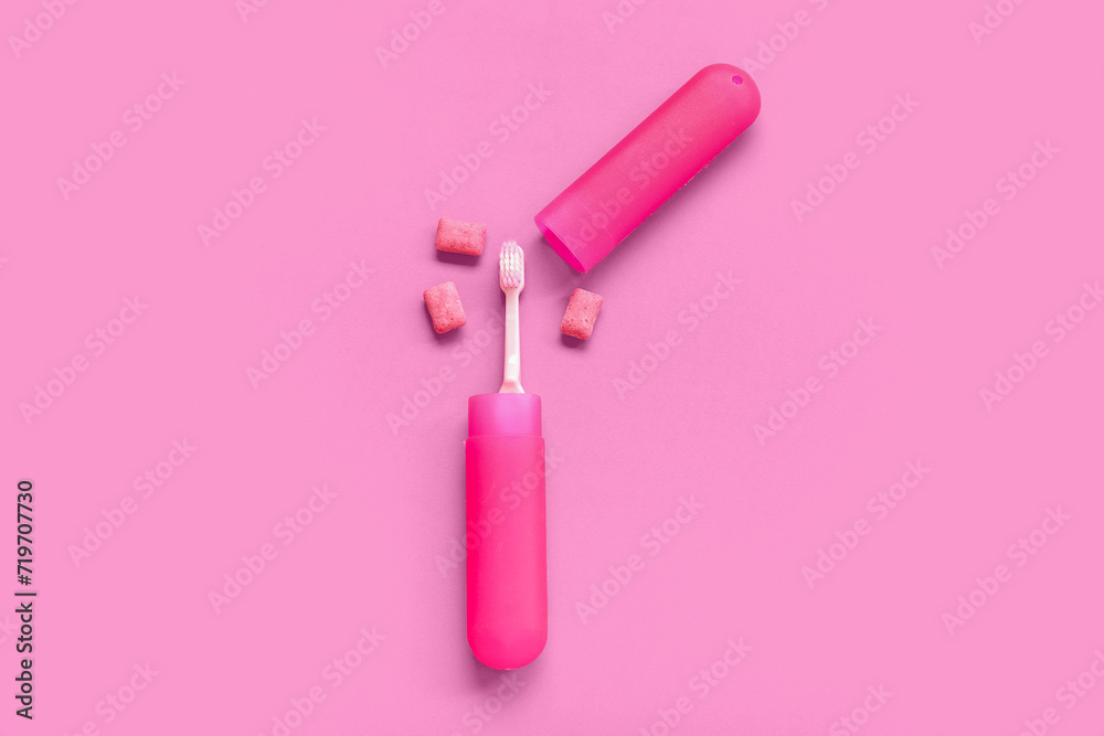 Container with toothbrush and chewing gums on pink background Container with toothbrush and chewing gums on pink background