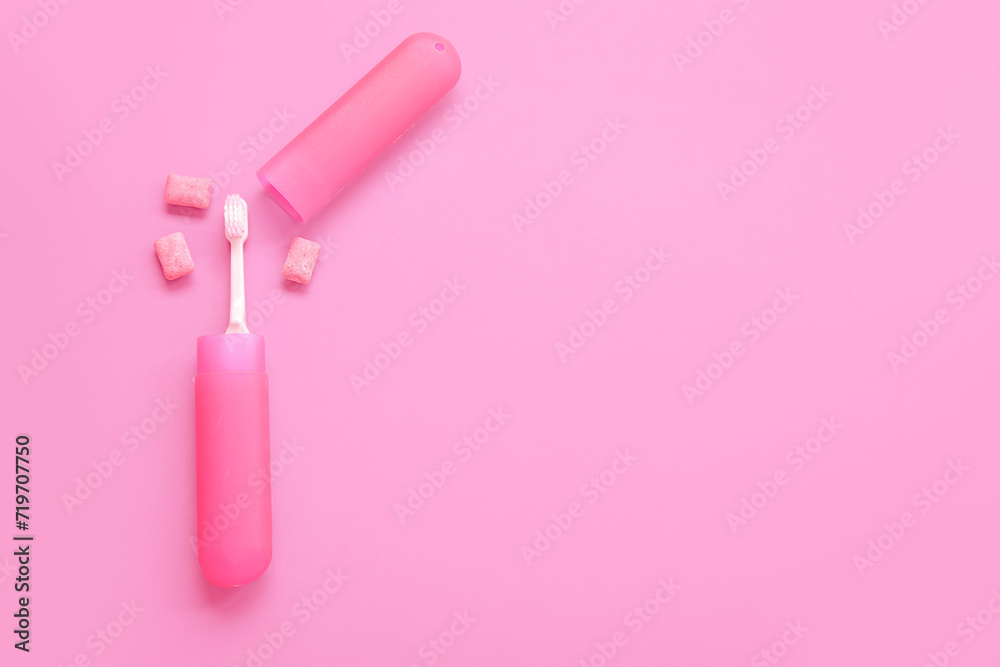 Container with toothbrush and chewing gums on pink background Container with toothbrush and chewing gums on pink background