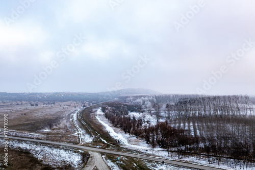 Frozen Pathways Above: Aerial Perspective of Snowy Countryside Road