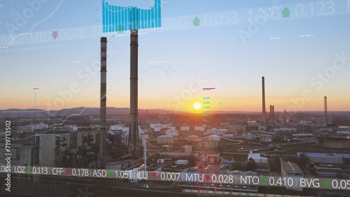 Fotografía Industrial Oil refinery plant with sunset in background and Wall Street Stock Market graphic